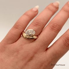 a woman's hand with a diamond ring on it