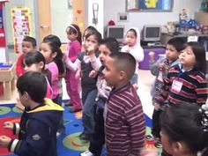 a group of children standing around each other