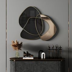 a black and gold sideboard in front of a gray wall with two mirrors on it