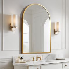 a bathroom with white walls and gold accents