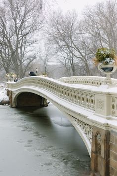 a bridge that is over some water in the snow