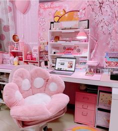 a pink chair sitting in front of a desk