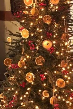 a christmas tree decorated with oranges and lights