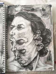 a drawing of a woman's face in black and white ink on a piece of paper