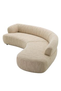 the curved couch is made out of fabric and has a rounded back, with an extended seat