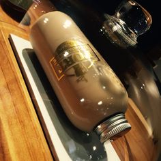 a brown bottle sitting on top of a wooden table