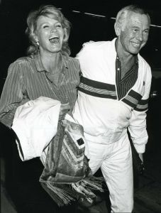 an older man and woman are walking together