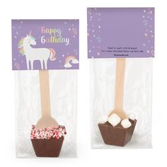 two wooden spoons with marshmallows in them