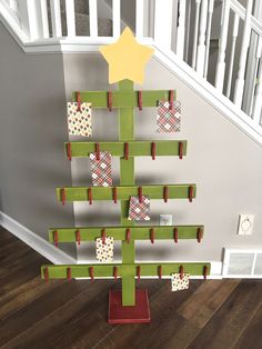 a christmas tree made out of wooden pegs on top of a hard wood floor