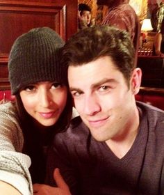 a man and woman taking a selfie in front of the camera at a restaurant