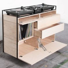 two turntables are sitting on top of a cabinet