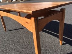 a wooden table sitting on top of a parking lot