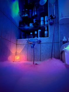 a bath room with a toilet and a tub filled with water next to a shelf