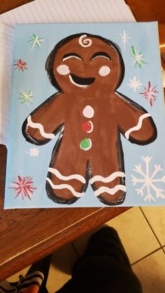 a child's drawing of a gingerbread man on a piece of paper with snowflakes