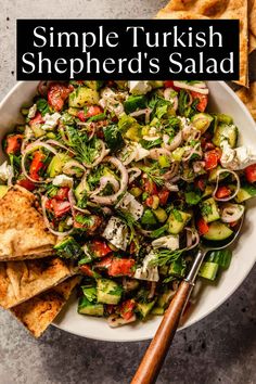 a white bowl filled with salad and pita chips