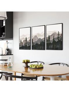 three paintings hanging on the wall above a dining room table with apples and pears