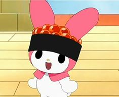 a cartoon rabbit with a pink hat and scarf on it's head, standing in front of a brick wall