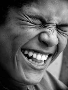 a black and white photo of a person laughing