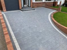 a brick driveway in front of a house