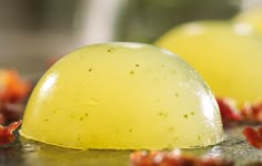 there are two pieces of fruit sitting on the counter top, one is yellow and the other is red