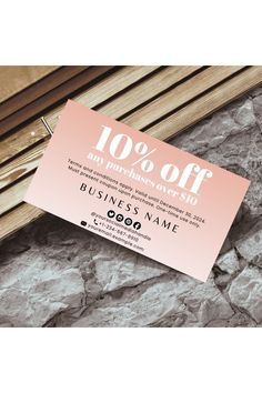 a business card with the words 100 % off on it next to some wood sticks