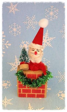 a santa clause sitting on top of a brick chimney