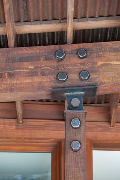 a close up of a wooden beam with metal rivets