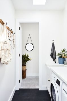 a washer and dryer in a white laundry room