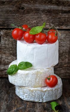 three tiered cake with cherry tomatoes on top