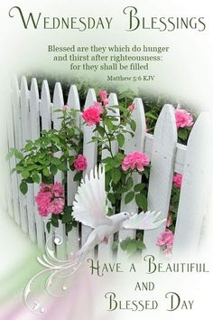 a white picket fence with pink flowers in it