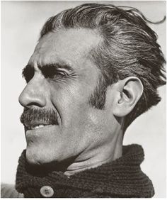 an old black and white photo of a man with a moustache on his face