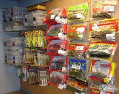 a wall filled with lots of different types of food in plastic containers and hanging from hooks