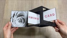 two hands are holding an open book with the words swing card on it and one hand is