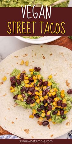 vegan street tacos with black beans, corn and guacamole in the background