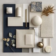 an assortment of white and blue items on a gray surface with gold accessories around them