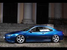 a blue car parked in front of some steps