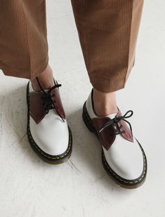 A patent leather tasseled loafer upper sits atop Dr. Martens’ signature classic air cushioned sole with the classic yellow topstitching. The Comme des Garcons iteration is of premium quality construction, created at the Cobbs Lane factory in the small village of Wollaston, Northamptonshire; the place where the legendary shoes were first made in 1960. - Made in England - 100% leather upper and insole - UK sizing Comme Des Garcons Shoes, Women Oxfords, Christopher Raeburn, Saddle Shoes, Boutique Sales, Popular Shoes, Doc Marten Oxford, Tassel Loafers, Modern Shop