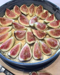 a pan filled with sliced up figs on top of a table