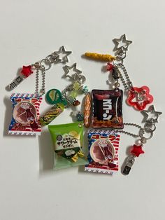 a bunch of charms that are laying on a white surface, one has candy and the other has candies