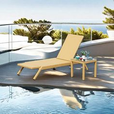 a lounge chair sitting on top of a swimming pool next to a large body of water