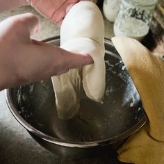 a person is making dough in a bowl