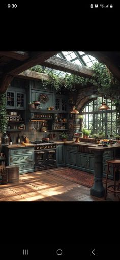 a kitchen with lots of green cupboards and plants on the counter top in front of an arched window