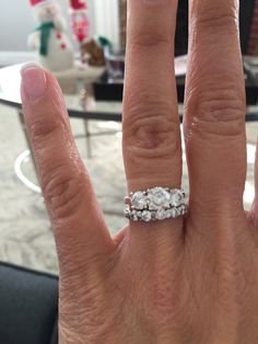 a woman's hand with a diamond ring on it