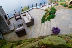 an outdoor patio area with seating and water view