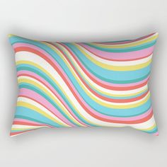 a rectangular pillow with multicolored wavy lines on the front and back of it