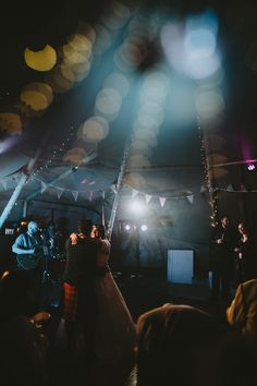 the bride and groom are dancing together at their wedding reception in a marquee