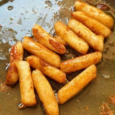 some fried food is being cooked in a frying pan