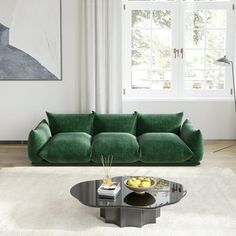 a living room with a green couch and coffee table