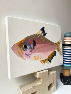 a painting of a fish on a white wall