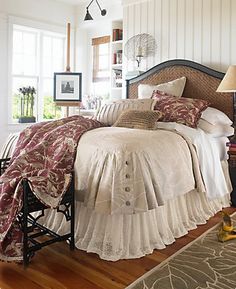 a bed sitting in a bedroom on top of a hard wood floor next to a window